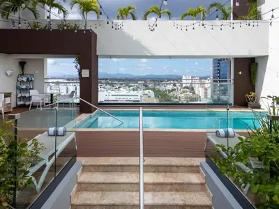 a swimming pool on the roof of a building at Homewood Suites By Hilton Santo Domingo in Santo Domingo