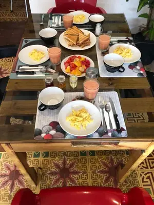 a wooden table with plates of food on it at La Aldea in Santo Domingo