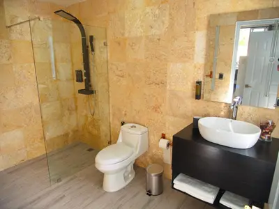 a bathroom with a toilet and a sink and a shower at La Aldea in Santo Domingo