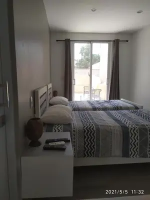 a bedroom with a bed with a table and a window at La Aldea in Santo Domingo