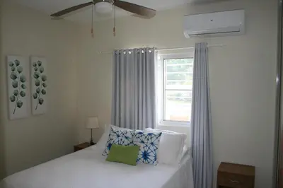 a bedroom with a bed and a window at Villa Deluxe Costambar in San Felipe de Puerto Plata