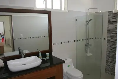 a bathroom with a sink and a shower and a toilet at Villa Deluxe Costambar in San Felipe de Puerto Plata