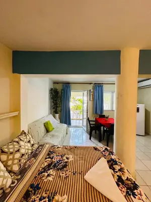 a living room with a couch and a table at Apartmenthotel Michaela in Sosúa