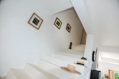 a white staircase in a house with hats on it at Casa Blava with AC in Las Galeras