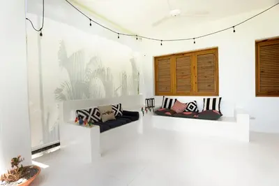 a white room with two couches on a wall at Casa Blava with AC in Las Galeras