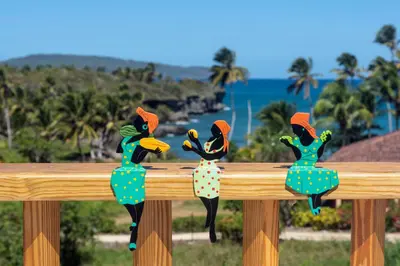 a pair of wooden birds on a wooden fence at Casa Blava with AC in Las Galeras
