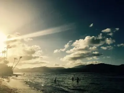 a group of people in the water at the beach at Labellaventura in Las Galeras