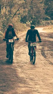two people riding motorcycles down a dirt road at Labellaventura in Las Galeras