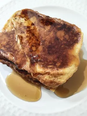 a piece of food on a plate with syrup at Micro Hotel Condo Suites in Santo Domingo
