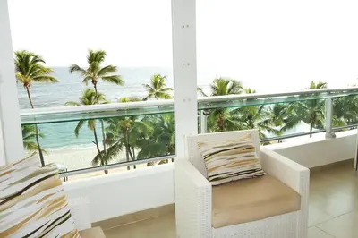 a balcony with a chair and a view of the ocean at Beach Apartment - Marbella, Juan Dolio!! Getaway Offer!! in Juan Dolio