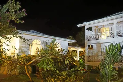 a white house with lights on at night at Hotel TODOBLANCO, Las Galeras, SAMANA in Las Galeras