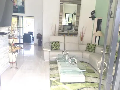 a living room with a couch and a table at Elegant Villa with Sea View in Sosúa | Private Pool in Sosúa