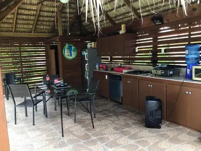 a kitchen with a table and chairs and a stove at Elegant Villa with Sea View in Sosúa | Private Pool in Sosúa