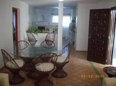 a dining room with a glass table and chairs at Dre Broeders Apartments Juan Dolio in Juan Dolio