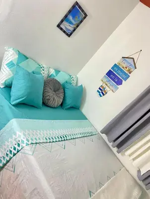 a room with a couch with blue pillows on it at Dre Broeders Apartments Juan Dolio in Juan Dolio