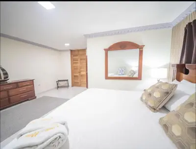 a bedroom with a large bed and a mirror at Home W Private Hot Tub, Near Everything in Sosua Center in Sosúa