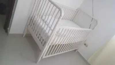 a white crib sitting in the corner of a room at 1Dom Rep - Huge cozy 3 bedrooms - close to all transportation Jacobo Majluta - Residencial Paradise V Colina Arroyo 1 in Santo Domingo
