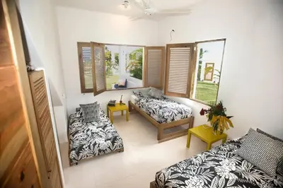 a living room with two beds and a couch at Villa Kalfu with AC in Las Galeras