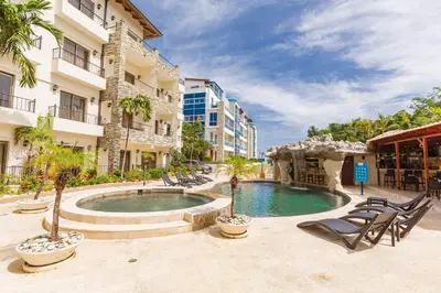 a swimming pool in the middle of a building at Suites at Grand Laguna Beach by Calisto Stays in Sosúa