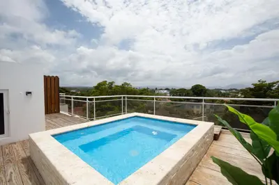 a swimming pool on the balcony of a house at Suites at Grand Laguna Beach by Calisto Stays in Sosúa