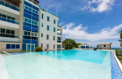 a large swimming pool in front of a building at Suites at Grand Laguna Beach by Calisto Stays in Sosúa