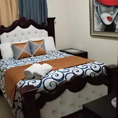 a bedroom with a bed with two towels on it at CONFORTABLE first floor en santiago RD in Santiago de los Caballeros