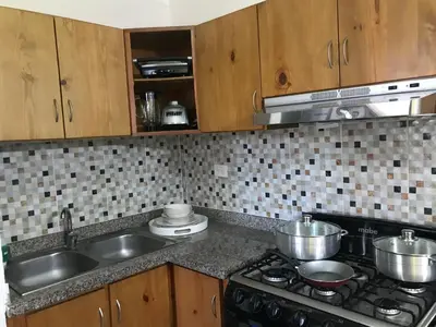 a kitchen with a stove and a sink with pots and pans at CONFORTABLE first floor en santiago RD in Santiago de los Caballeros