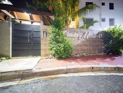 a garage with a sign on the side of a building at Cozy 2br-2bt Apt Near The Beach And Main Street in Sosúa