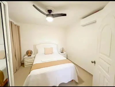 a bedroom with a bed with a ceiling fan at Fully Equipped New 2br Aptdt2mins To The Beach in Sosúa