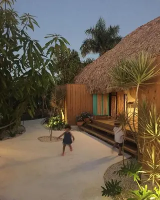 a small child walking in front of a building at Bungalow with pool and Air Conditioning near playa Macao in Punta Cana