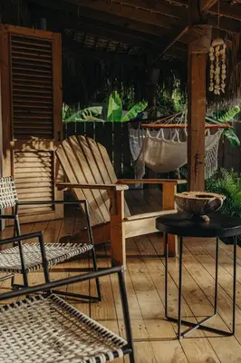 a porch with a rocking chair and a hammock at Bungalow with pool and Air Conditioning near playa Macao in Punta Cana