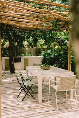 a white table with two chairs and a table with at Bungalow with pool and Air Conditioning near playa Macao in Punta Cana