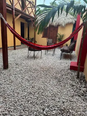 a hammock in the courtyard of a building at Hotel Loro Tuerto in Santa Cruz de Barahona