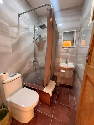 a bathroom with a shower and a toilet and a sink at Hotel Loro Tuerto in Santa Cruz de Barahona