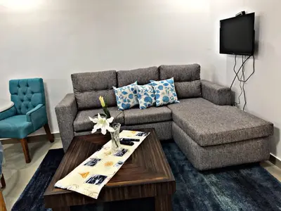 a living room with a couch and a coffee table at Fully Equipped New 1br Apt dt 2mins To Beach in Sosúa
