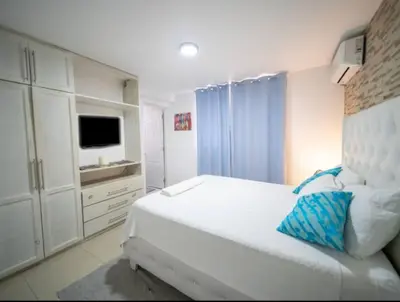 a white bedroom with a bed and a tv at Fully Equipped New 3br Apt dt 2mins To The Beach in Sosúa
