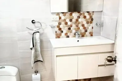 a bathroom with a sink and a toilet at Spacious house in Santo Domingo Este with garden in Santo Domingo