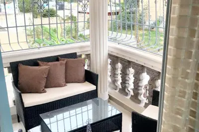 a bench sitting in a room with two windows at Spacious house in Santo Domingo Este with garden in Santo Domingo