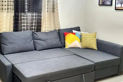 a gray couch with pillows in a living room at Spacious house in Santo Domingo Este with garden in Santo Domingo