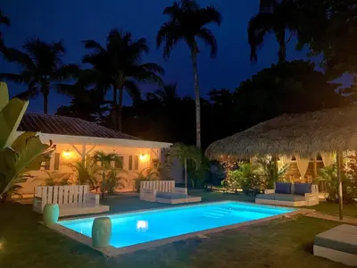 a villa with a swimming pool at night at PUNTA POPY BOUTIQUE HOTEL - Adults Only in Las Terrenas