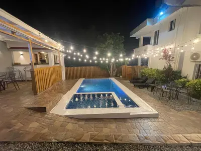 a swimming pool in the middle of a patio at night at Casa Docia Hotel in Santa Bárbara de Samaná
