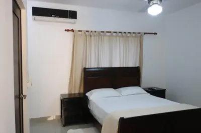 a bedroom with a bed and a window at Tu Segundo Hogar en Santiago, La Cuidad CORAZÓN in Santiago de los Caballeros