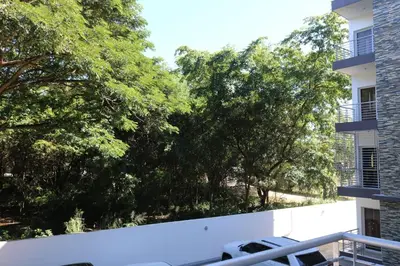 a view from the balcony of a building with trees at Tu Segundo Hogar en Santiago, La Cuidad CORAZÓN in Santiago de los Caballeros