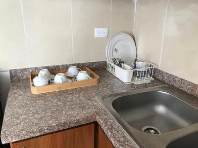 a kitchen counter with a sink and a mirror at cómodo first floor in Santiago de los Caballeros