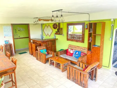 a room with wooden tables and chairs in a restaurant at Private Rooms-Art Punta Cana in Punta Cana