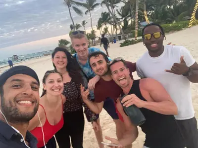 a group of people posing for a picture on the beach at Private Rooms-Art Punta Cana in Punta Cana