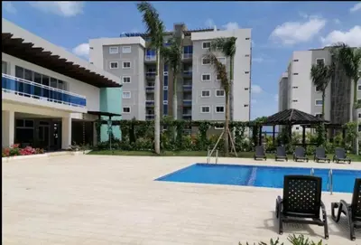 a resort with a swimming pool and two buildings at Paraiso de verano in Santiago de los Caballeros