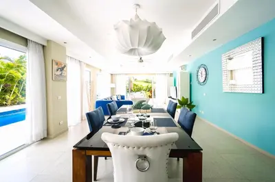 a dining room with a table and blue walls at Luxury Villa Iberosta Del Mar - 4BDR, Private Beach, Pool & Jacuzzi in Punta Cana