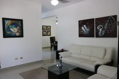 a living room with a couch and a table at Apartamento Amueblado Amplio Tranquilo Privado Como tu lo Mereces in Santiago de los Caballeros