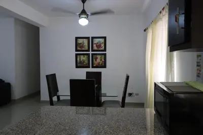 a kitchen and dining room with a table and chairs at Apartamento Amueblado Amplio Tranquilo Privado Como tu lo Mereces in Santiago de los Caballeros